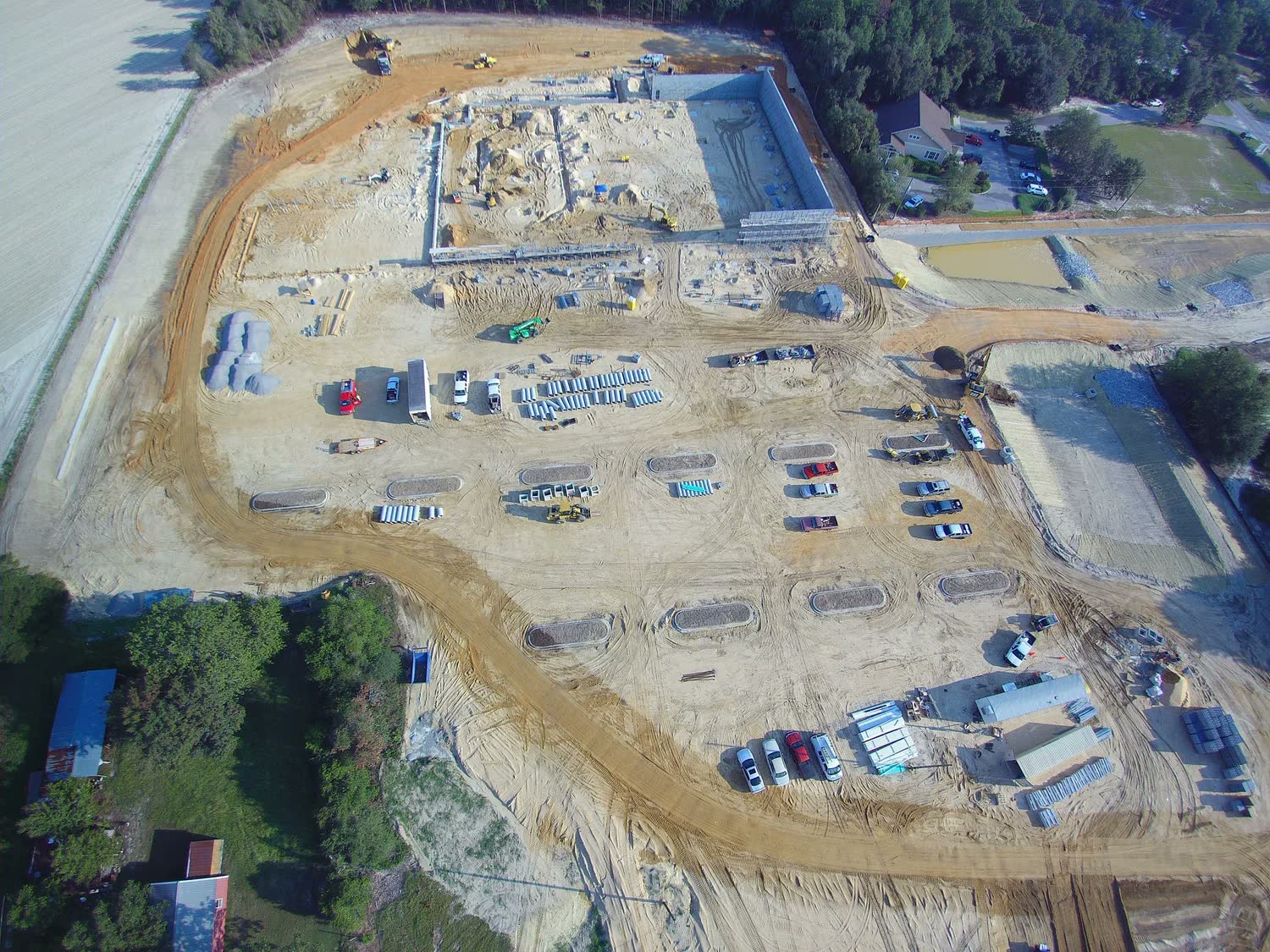 Graded building pad at Lowe’s, with forms and material stockpiles.